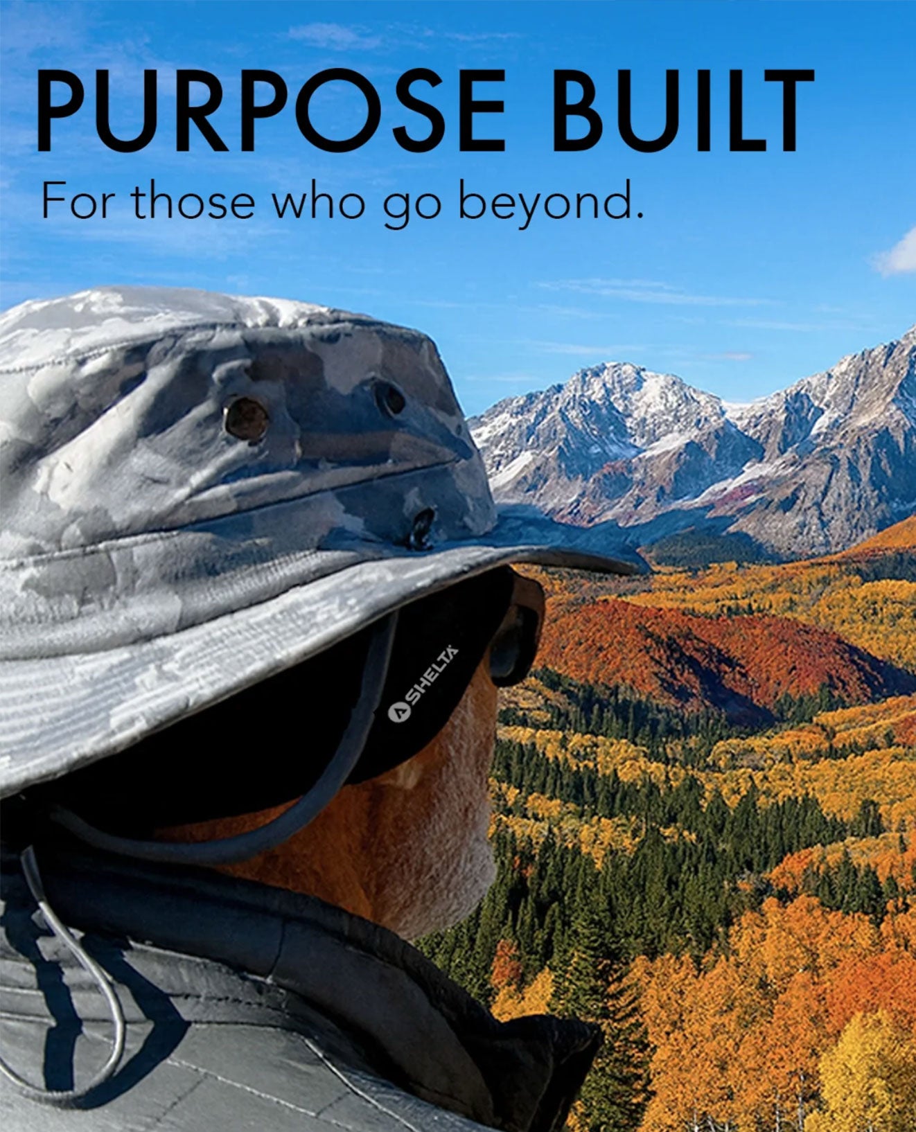 Person wearing a wide-brimmed hat with a scenic mountain and forest view, featuring the text 'Purpose Built: For those who go beyond.'.