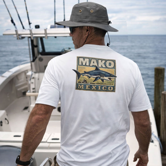 Man on a boat wearing a white t-shirt with 'Mako Mexico' graphic