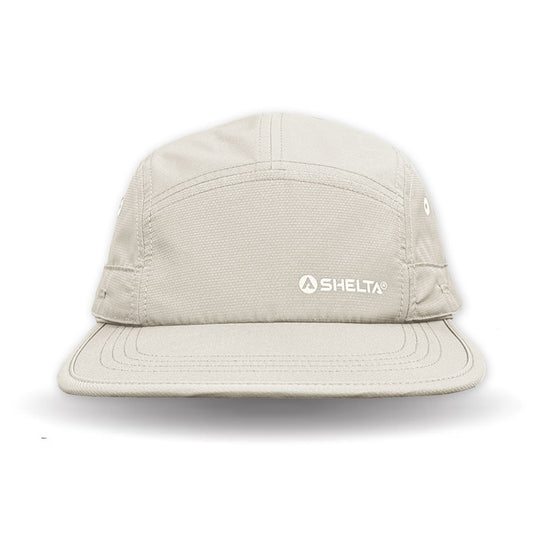Beige cap with Shelta logo on a white background