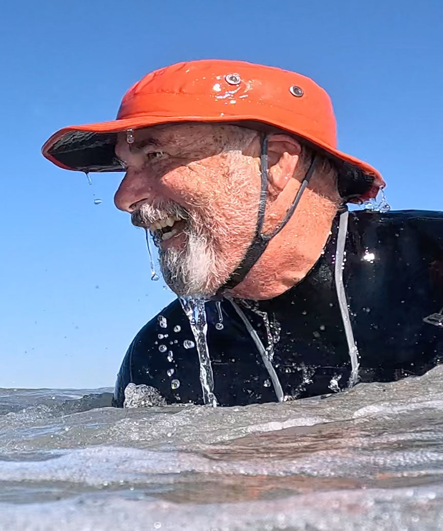 Surfer in water wearing shetla hat