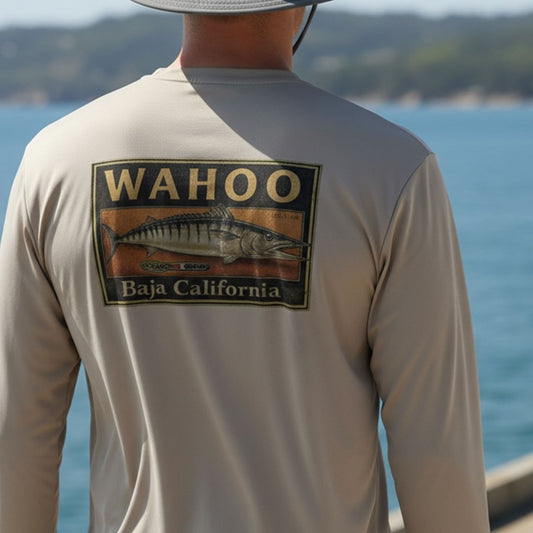 Person wearing a shirt with 'Wahoo Baja California' logo by the water