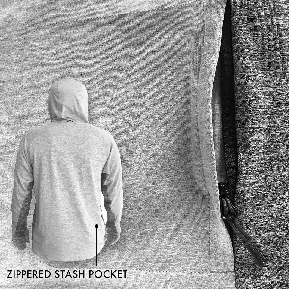 Person wearing a hoodie with a zipped stash pocket on a textured fabric background