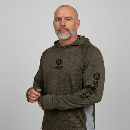 Man wearing a green hoodie with 'SHELTA' logo on a gray background