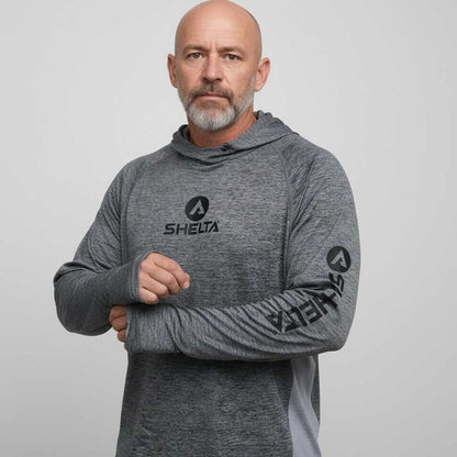 Man wearing a gray hoodie with 'SHELTA' branding on a light gray background
