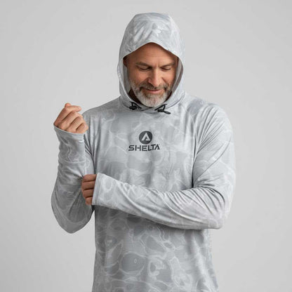 Man wearing a gray hooded shirt with a brand logo on a light gray background