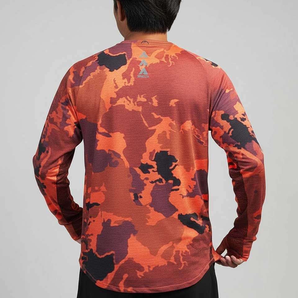 Person wearing a long-sleeve camouflage shirt with a visible brand logo on a gray background