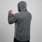 Person wearing a gray hoodie with a logo on the back against a light gray background