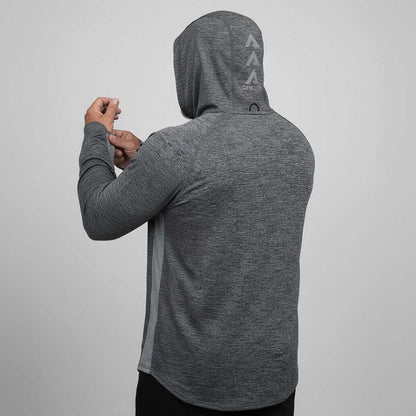Person wearing a gray hoodie with a logo on the back against a light gray background