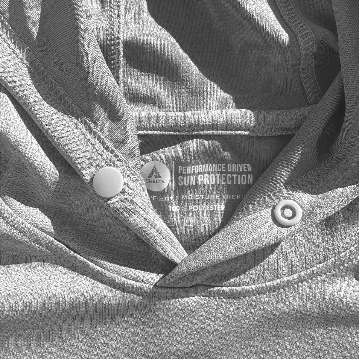 Close-up of a label on a piece of clothing with text and branding.
