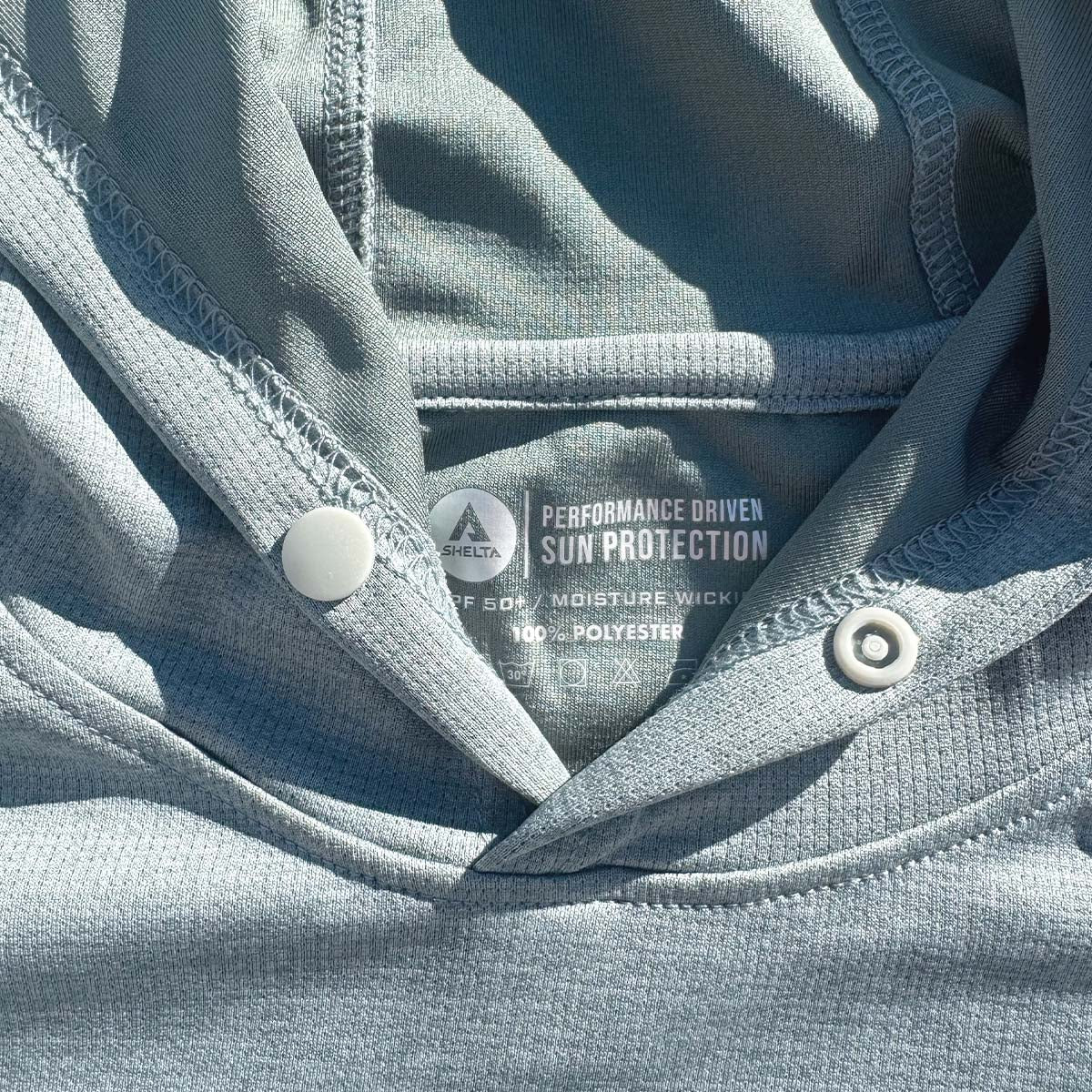 Close-up of a gray shirt with sun protection label