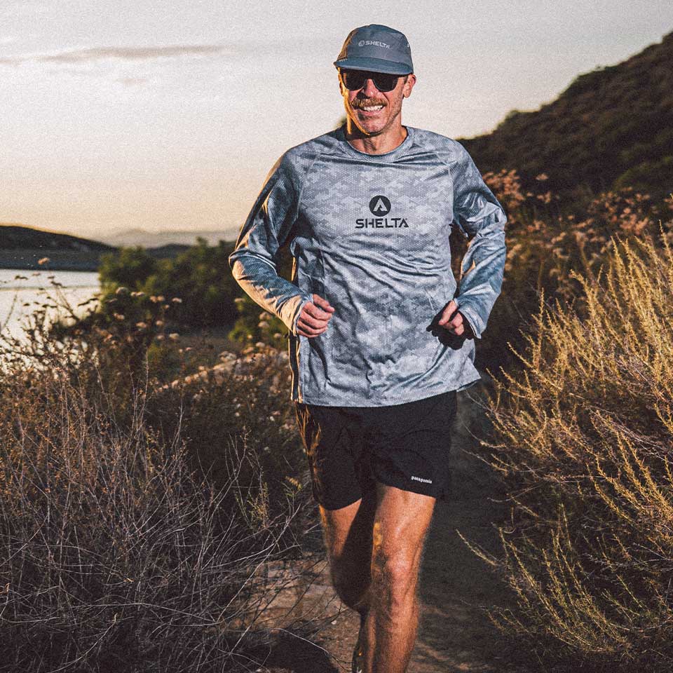 Man running outdoors with a scenic background