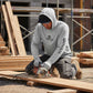 Person wearing a Shelta hoodie using a power tool on a construction site