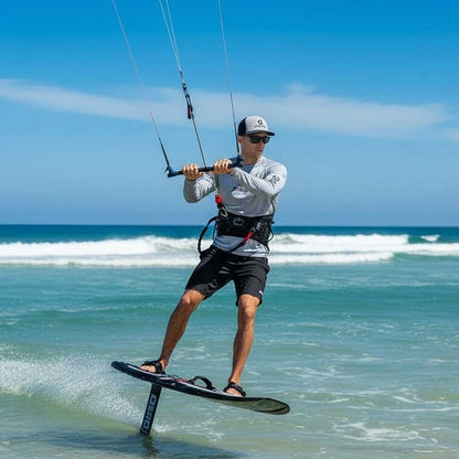 Person kiteboarding on a clear day at the beach