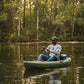 Man fishing from a kayak on a calm lake surrounded by trees