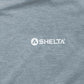 Close-up of a gray fabric surface with 'Selta' logo.