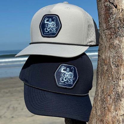 7 seas cap in Navy and silver hat by beach
