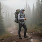 Hiker with a backpack on a misty forest path