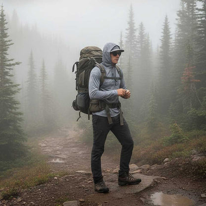 Hiker with a backpack on a misty forest path