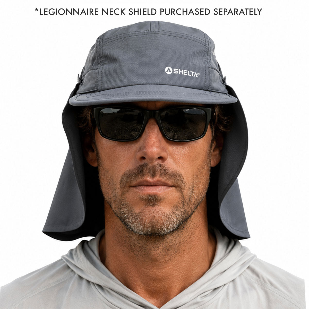 A man wearing a gray Shelta legionnaire neck shield hat with an attached neck flap, black sunglasses, and a light gray hoodie. Text at the top reads '*LEGIONNAIRE NECK SHIELD PURCHASED SEPARATELY'.