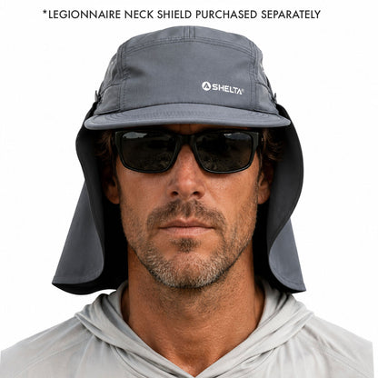 A man wearing a gray Shelta legionnaire neck shield hat with an attached neck flap, black sunglasses, and a light gray hoodie. Text at the top reads '*LEGIONNAIRE NECK SHIELD PURCHASED SEPARATELY'.