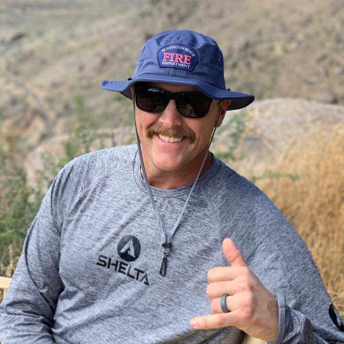a man wearing a shelta sun hat and a shelta sun shirt 