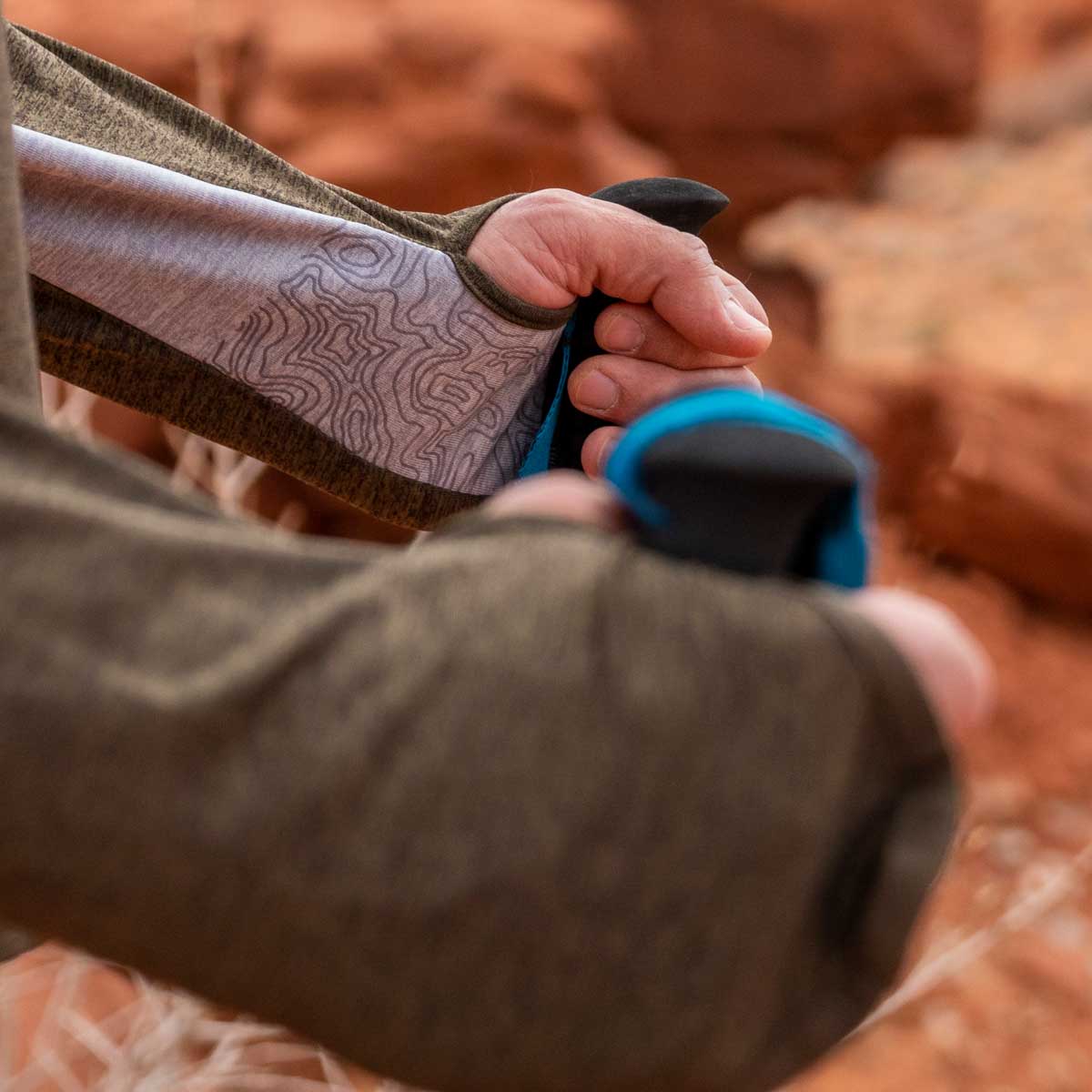 close up the sleeve tech on the hands of a hiker