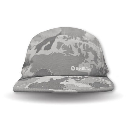 Camouflage-patterned cap with 'SHELTA' logo on a white background
