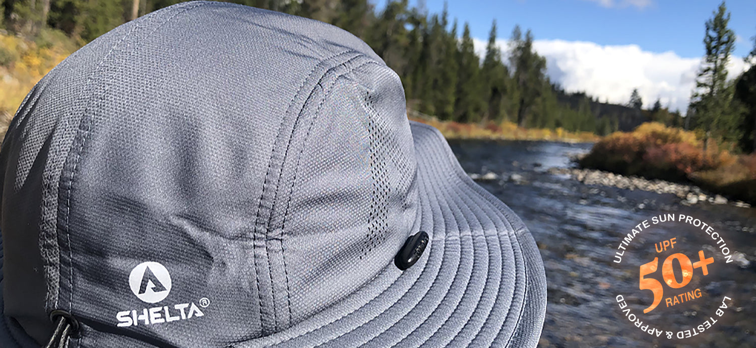 picture of the back of a shelta sun hat with a stream in view