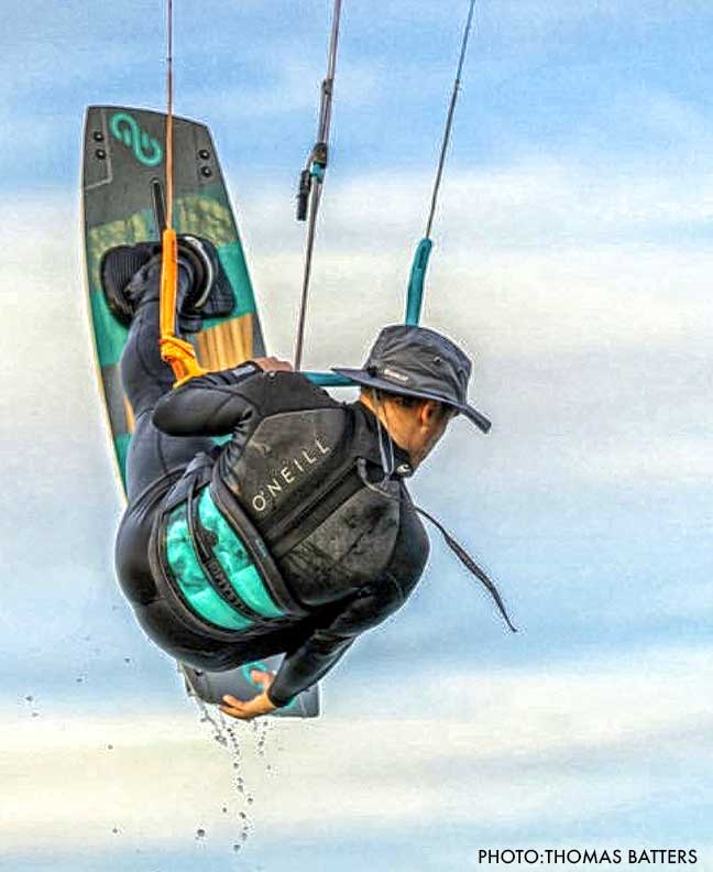 a person flying in the sky while kiteboarding