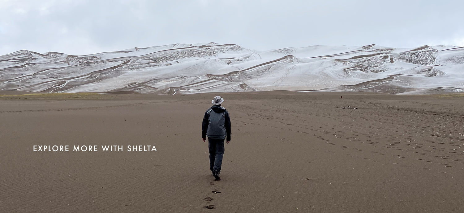 Picture of man walking away on sand with background image