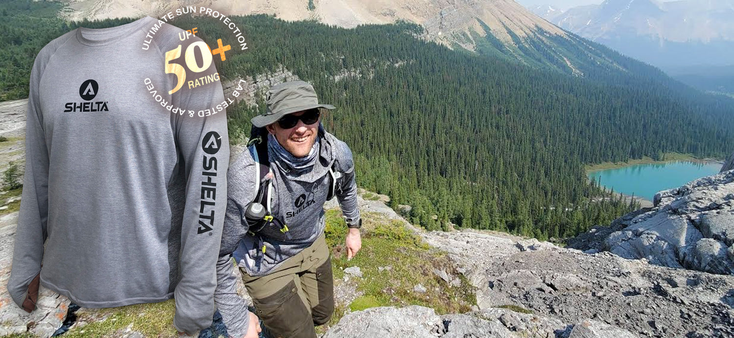 Picure of hiker wearing Shelta Sun Shirt and Shelta sun hat with lake in background