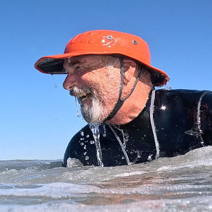 MAN WEARING A SHELTA OSPREY IN THE OCEAN