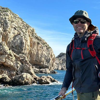 person on a boat wearing a backpack and shelta osprey