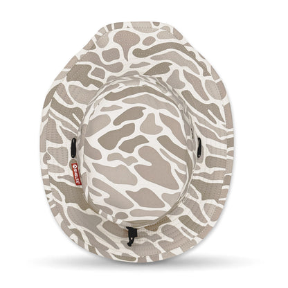 Camouflage-patterned hat with a visible brand label on a white background