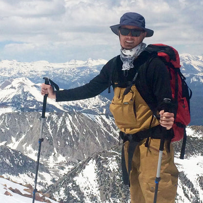 a man wearing a shelta sun hat while cross country skiing