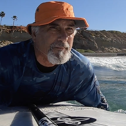 Surfer wearing the Osprey Sun Hat in Blaze Orange