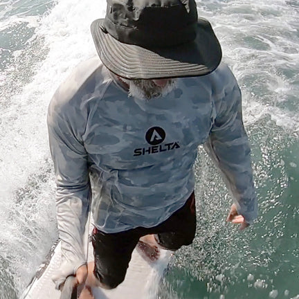 Picture of man stand up surfing with Hat and Shirt