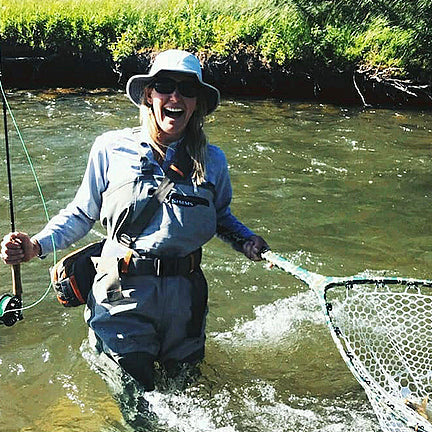 Women wearing a condor sun hat fishing