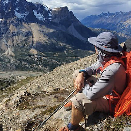 Man looking at mountains wearing a Shelta Firebird V2 Storm Grey  Sun Hat