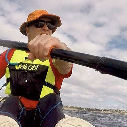 Kayaking with the Raptor sun hat in blaze orange