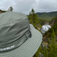 Back view of Dirty Olive Land Hawk sun hat look over trees